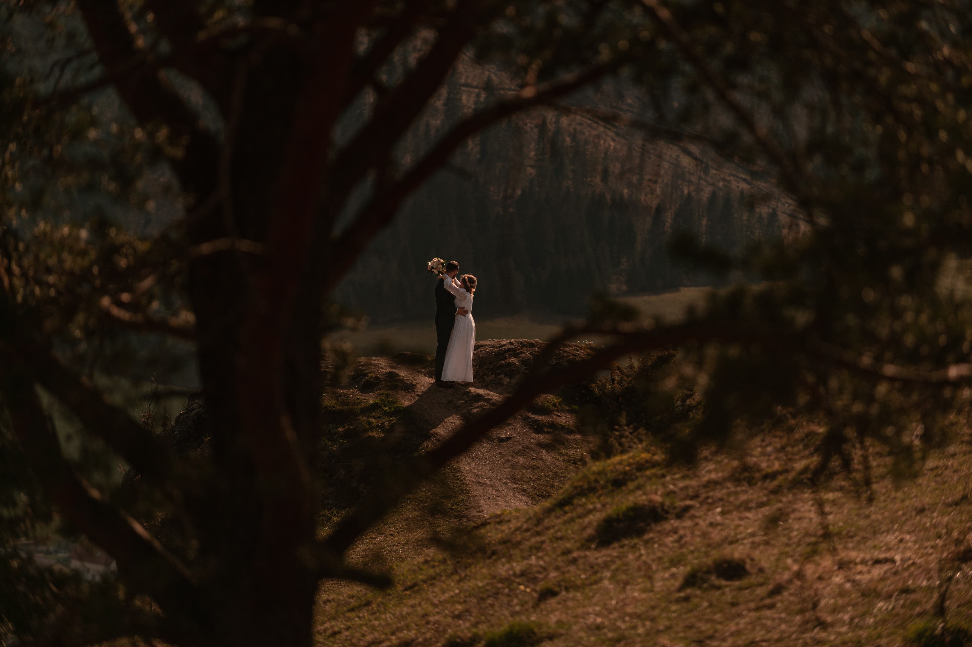 Photo of marriage standing on top of the mountain